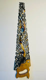 Hand cut, flame painted saw.